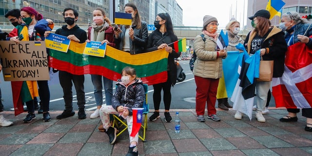 Demonstrators holding placards that read We are all Ukrainians today,  and national flags of Ukraine, Denmark, Estonia, Lithuania and Poland, during a protest against Russian live-fire attacks on Ukraine, outside the Moscow-Taipei Coordination Commission in Taiwan, in Taipei, Taiwan, 25 February 2022. Several western countries including the US and UK  have imposed sanctions on Russia, with Baltic States members including Lithuania and Estonia showing support of Ukraine.  