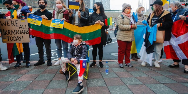 Demonstrators holding placards that read We are all Ukrainians today,  and national flags of Ukraine, Denmark, Estonia, Lithuania and Poland, during a protest against Russian live-fire attacks on Ukraine, outside the Moscow-Taipei Coordination Commission in Taiwan, in Taipei, Taiwan, 25 February 2022. Several western countries including the US and UK  have imposed sanctions on Russia, with Baltic States members including Lithuania and Estonia showing support of Ukraine.  