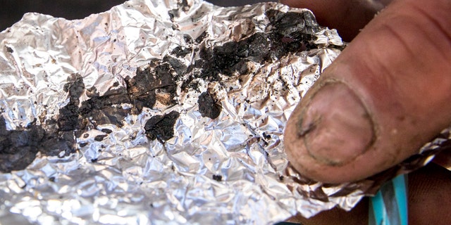 Roger Boyd, 35, holds a piece of foil containing Fentanyl while spending time on McAllister Street in the Tenderloin district of San Francisco, Calif. The city's health agency issued a warning Thursday after learning of three fentanyl-related overdose deaths within the past two weeks.