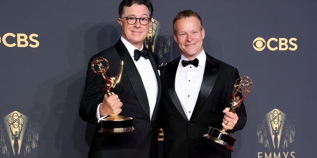 LOS ANGELES, CALIFORNIA - SEPTEMBER 19: (L-R) Stephen Colbert and Chris Licht, winners of the Outstanding Variety Special (Live) award on September 19, 2021 in Los Angeles, California. (Photo by Rich Fury/Getty Images)