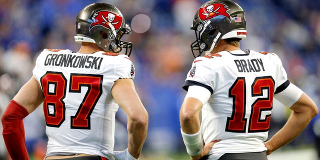 Tom Brady #12 and Rob Gronkowski #87 of the Tampa Bay Buccaneers talk before the game against the Indianapolis Colts at Lucas Oil Stadium on November 28, 2021 in Indianapolis, Indiana.