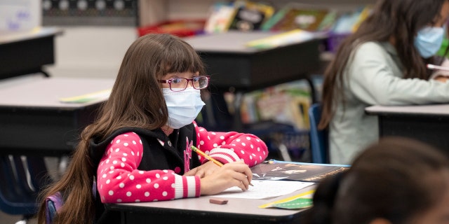 A student listens to her teacher in a second and third grade class at Robert M. Pyles STEM Academy in Stanton, Calif., Jan. 13, 2022. 