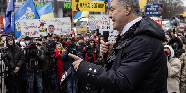 Ukraine's former President Petro Poroshenko speaks to supporters and media outside the Kyiv District Court of Appeal on Jan. 28, 2022.