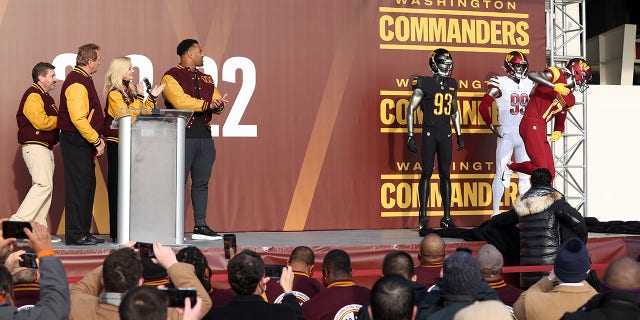 Team co-owners Dan and Tanya Snyder, former player Joe Theismann, and current player Jonathan Allen unveil the new team uniforms during the announcement of the Washington Football Team's name change to the Washington Commanders at FedExField on February 02, 2022, in Landover, Maryland.