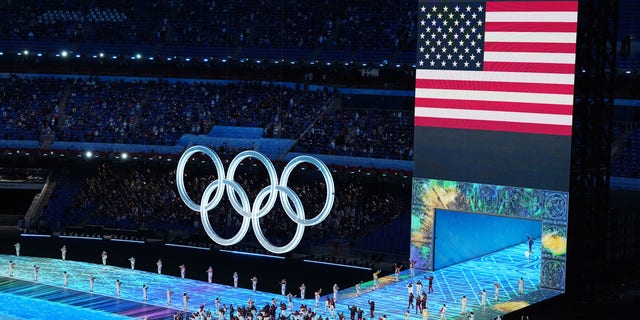 Flag bearers Brittany Bowe and John Shuster of Team United States carry their flag during the Opening Ceremony of the Beijing 2022 Winter Olympics at the Beijing National Stadium on February 4, 2022 in Beijing, China. 