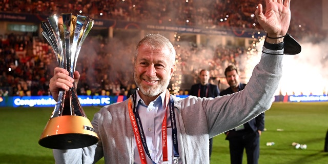 Roman Abramovich, owner of Chelsea, celebrates with the FIFA Club World Cup trophy after a victory during the FIFA Club World Cup UAE 2021 final match between Chelsea and Palmeiras at Mohammed Bin Zayed Stadium Feb. 12, 2022, in Abu Dhabi, United Arab Emirates.