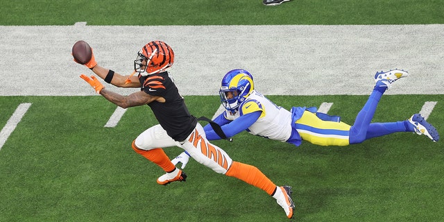 Ja'Marr Chase #1 of the Cincinnati Bengals makes a catch over Jalen Ramsey #5 of the Los Angeles Rams during Super Bowl LVI at SoFi Stadium on February 13, 2022 in Inglewood, California. 