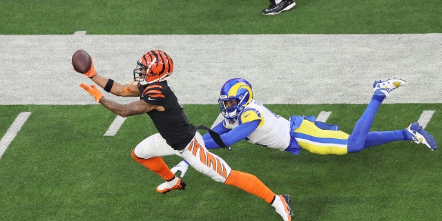 Ja'Marr Chase #1 of the Cincinnati Bengals makes a catch over Jalen Ramsey #5 of the Los Angeles Rams during Super Bowl LVI at SoFi Stadium on February 13, 2022 in Inglewood, California.