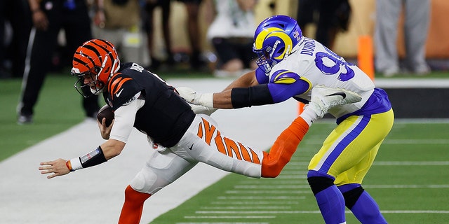 Aaron Donald #99 of the Los Angeles Rams pushes Joe Burrow #9 of the Cincinnati Bengals out of bounds in the third quarter during Super Bowl LVI at SoFi Stadium on February 13, 2022 in Inglewood, California. 