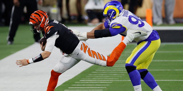 Aaron Donald #99 of the Los Angeles Rams pushes Joe Burrow #9 of the Cincinnati Bengals out of bounds in the third quarter during Super Bowl LVI at SoFi Stadium on February 13, 2022 in Inglewood, California. 