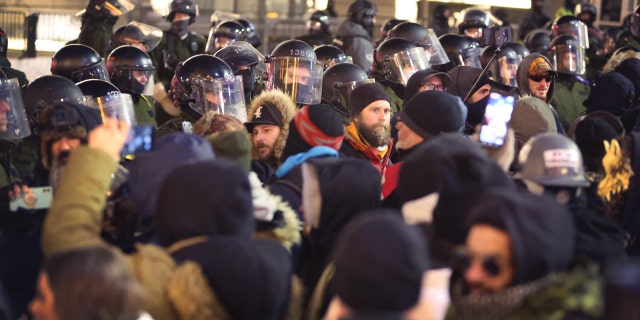 Police face off with demonstrators participating in a protest organized by truck drivers opposing vaccine mandates on February 18, 2022 in Ottawa, Ontario, Canada. (Photo by Scott Olson/Getty Images)