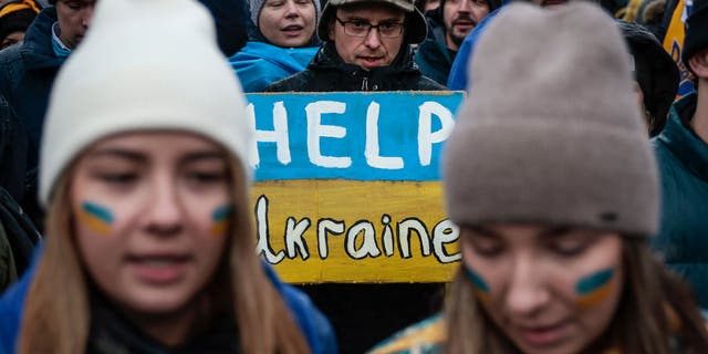 Anti-war demonstrators Elena Quills and Alexandra Yashan take part in a rally with Ukrainians and supporters during a protest in Lafayette Park on February 24, 2022 in Washington, DC