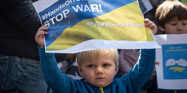 A child holds a placard during a protest against Russia's attack on Ukraine in front of Shibuya station on Feb. 26, 2022 in Tokyo, Japan.