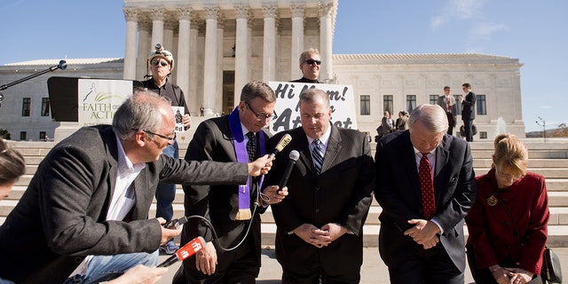 Religious activists pray outside the Supreme Court in Washington, DC. (SAUL LOEB/AFP via Getty Images)