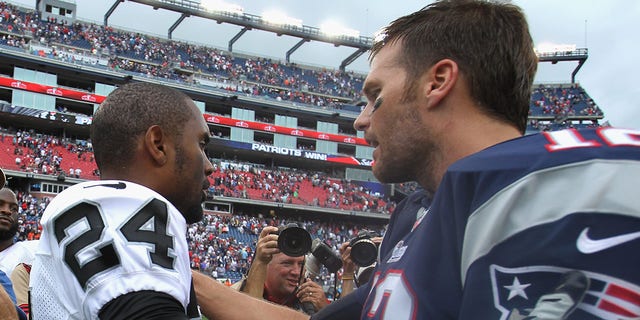 Charles Woodson of the Oakland Raiders shakes hands with Tom Brady of the New England Patriots after the game at Gillette Stadium on Sept. 21, 2014, in Foxboro, Massachusetts.