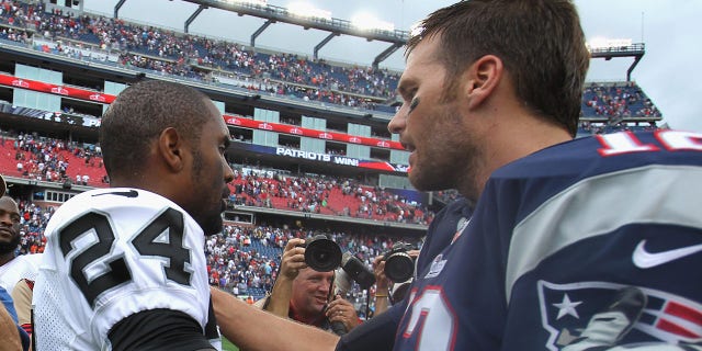 Charles Woodson of the Oakland Raiders shakes hands with Tom Brady of the New England Patriots after the game at Gillette Stadium on Sept. 21, 2014, in Foxboro, Massachusetts.
