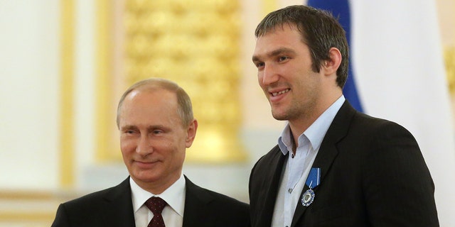 Russian President Vladimir Putin and Alexander Ovechkin stand together during a reception at the Kremlin in Moscow on May 27, 2014.