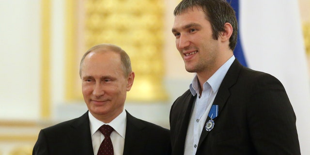 Russian President Vladimir Putin (L) and Russian Ice Hockey Team player Alexander Ovechkin stand together during a reception in the Kremlin for the national team, who won the 2014 Ice Hockey World Championship, May 27, 2014, in Moscow, Russia.