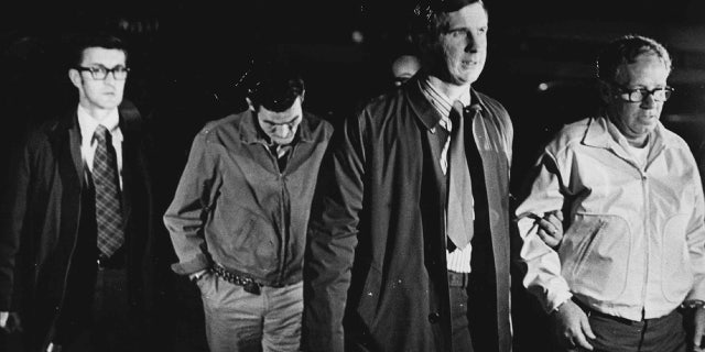 Carl Taylor And Sherman McCrary, right, in custody. Escorting the prisoners is Lakewood Agent Joe Fancuilli.