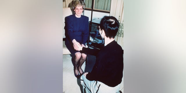 Princess Diana shakes hands with an AIDS patient as she opens a new AIDS ward at the Middlesex Hospital on April 9, 1987, in London, England. 