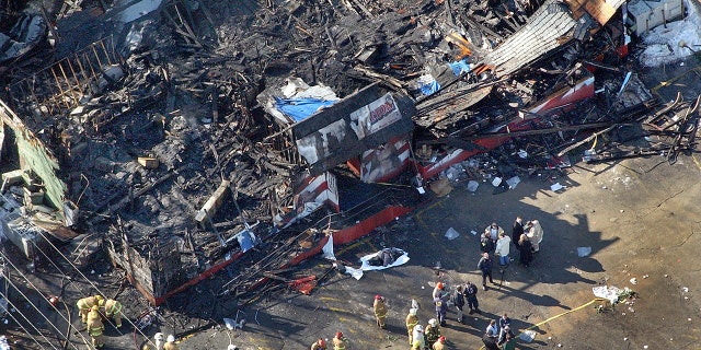 Station nightclub fire scene, viewed from above. The one-story building burned to the ground in about three minutes. The fire was started by pyrotechnics going off on stage while the band Great White performed. View of the front door and parking lot.