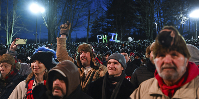 The crowd watches the festivities while waiting for Punxsutawney Phil, the weather prognosticating groundhog, to come out and make his prediction.