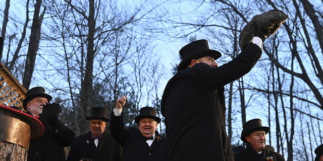 Groundhog Club handler A.J. Dereume holds Punxsutawney Phil, the weather prognosticating groundhog, during the 136th celebration of Groundhog Day on Gobbler's Knob in Punxsutawney, Pa., on Wednesday.