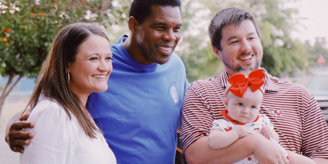 Herschel Walker poses with supporters in Georgia.