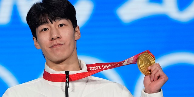 Gold medalist Hwang Dae-heon of South Korea celebrates during the medal ceremony for the men's 1500-meters short track speedskating during the 2022 Winter Olympics, Thursday, Feb. 10, 2022, in Beijing.