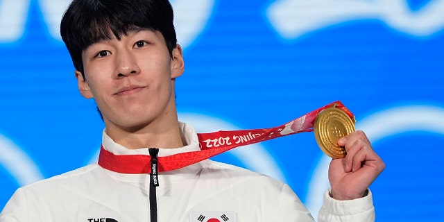 Gold medalist Hwang Dae-heon of South Korea celebrates during the medal ceremony for the men's 1500-meters short track speedskating during the 2022 Winter Olympics, Thursday, Feb. 10, 2022, in Beijing.
