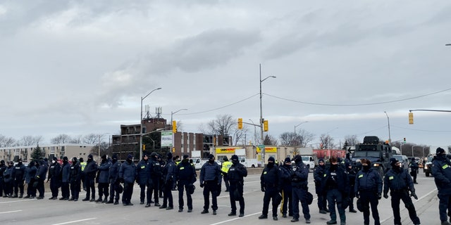 Police in riot gear stormed a rally on Sunday, removing hundreds of protesters by truck