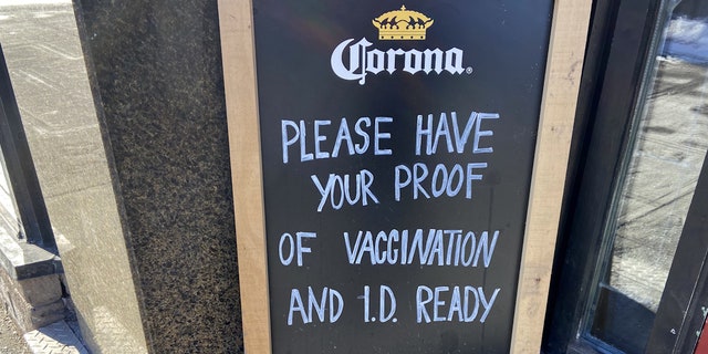 A sign outside a restaurant in downtown Ottawa asks for proof of vaccination.