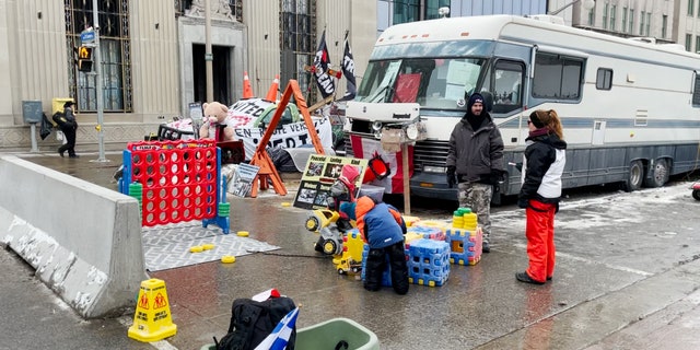 Children play outside the Parliament of Canada at the Freedom Convoy.