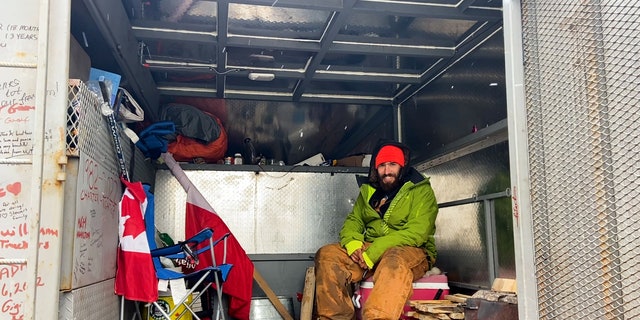 Inside the truck of a Canadian driver, Adrien de Medeiros, he sets up a hammock to sleep in at night