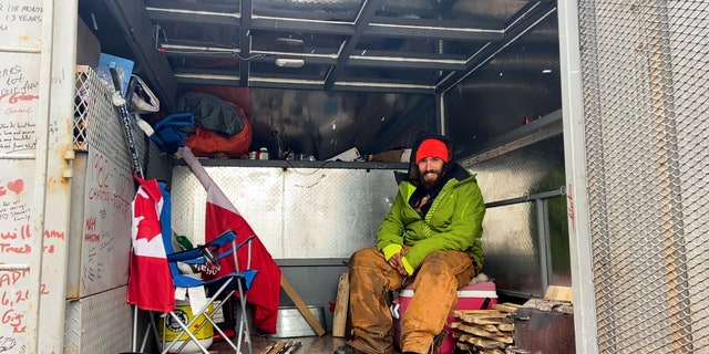 Inside the truck of a Canadian driver, Adrien de Medeiros, he sets up a hammock to sleep in at night