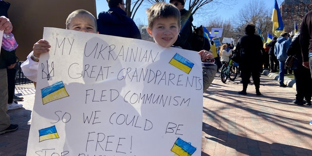 Children hold a sign outside the White House at a pro-Ukraine protest