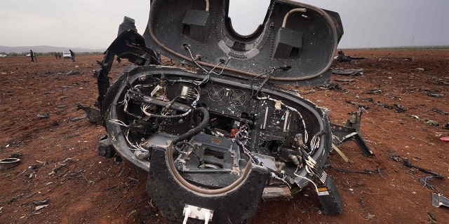 The remains of a U.S. helicopter in the village of Jinderes on Feb. 3, 2022, following an overnight raid by U.S. special operations forces against ISIS' leader.