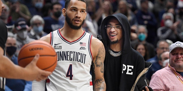 Charlotte Hornets rookie guard James Bouknight talks to Connecticut's Tyrese Martin during the Feb. 19, 2022, game against Xavier in Storrs, Connecticut.