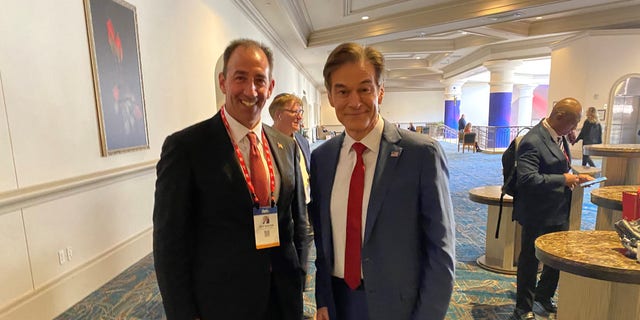 Pennsylvania GOP Senate candidates Dr. Oz (right) and Jeff Bartos cross paths while at the Conservative Political Action Conference (CPAC) in Orlando, Fla. Feb. 25, 2022.