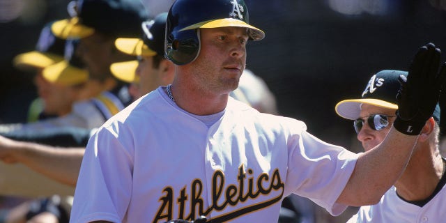 Jeremy Giambi #7 of the Oakland Athletics gives a high five during a game against the Chicago White Sox at the Network Associates Coliseum in Oakland, California. The Athletics defeated the White Sox 14-2.