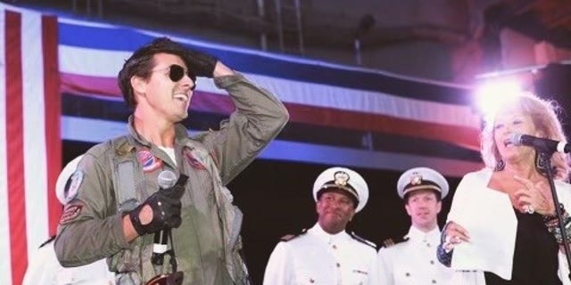 Jerome LeBlanc, left, impersonates Tom Cruise's "Top Gun" character, Lt. Pete "Maverick," Mitchell at an event.