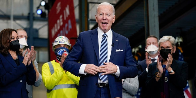 President Biden reacts after signing an executive order on project labor agreements at the Ironworkers Local 5 in Upper Marlboro, Md., Friday, Feb. 4, 2022. Vice President Kamala Harris, left, and Energy Secretary Jennifer Granholm, right, applaud. 
