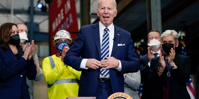 President Biden reacts after signing an executive order on project labor agreements at the Ironworkers Local 5 in Upper Marlboro, Md., Friday, Feb. 4, 2022. Vice President Kamala Harris, left, and Energy Secretary Jennifer Granholm, right, applaud.