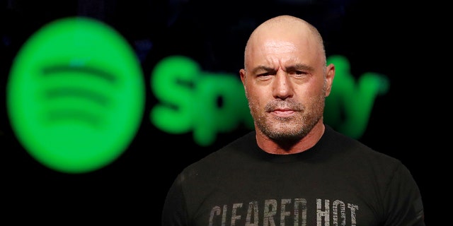 Joe Rogan is seen in the foreground, with a Spotify logo behind him, in a Fox News photo illustration.
