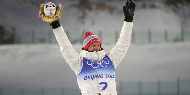 Johannes Thingnes Boe of Norway poses during the venue ceremony after the men's 15-kilometer mass start biathlon at the 2022 Winter Olympics, Friday, Feb. 18, 2022, in Zhangjiakou, China.