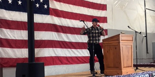 Student leader Lucas Johnson of Connecticut on stage, speaking out firmly about his beliefs.