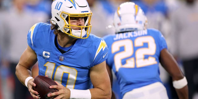 Justin Herbert of the Los Angeles Chargers looks to pass during a 34-28 loss to the Kansas City Chiefs at SoFi Stadium on Dec. 16, 2021 in Inglewood, California.