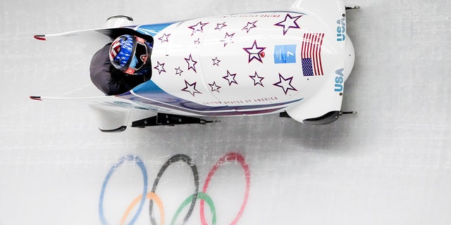 Kaillie Humphries and Kaysha Love, of the United States, slide during the women's bobsleigh heat 1 at the 2022 Winter Olympics, Friday, Feb. 18, 2022, in Beijing. 