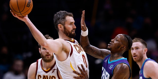 Terry Rozier (3) of the Charlotte Hornets defends Kevin Love (0) of the Cleveland Cavaliers during the second half of their game at Spectrum Center Feb. 4, 2022, in Charlotte, N.C.