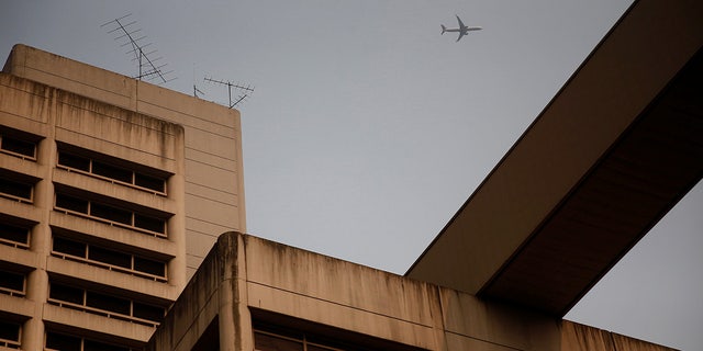 A plane flies overhead the King County Correctional Facility in downtown Seattle.